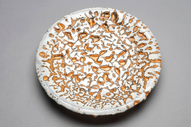 ROUND WHITE, ORANGE, BLACK MOTTLED WALL PLATE